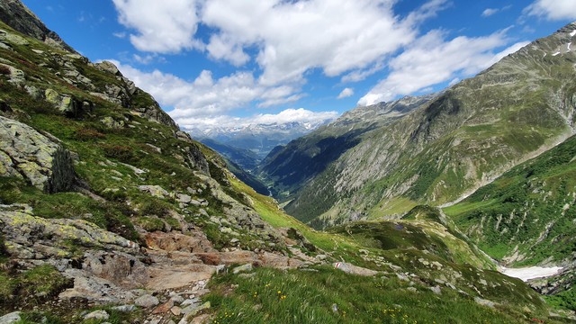 Blick in das Val Sumvitg und die Surselva. Im Vordergrund ist ein Bergwanderweg zu sehen mit der weiss-rot-weissen Markierung.