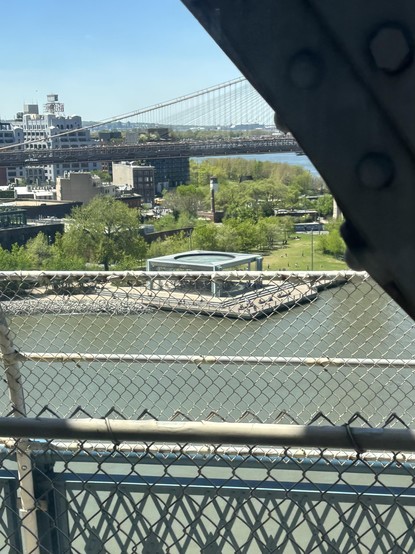 That carousel wrapped in glass, but it’s hard to see with the fence running through it from our bridge. On the Q train to Brooklyn.