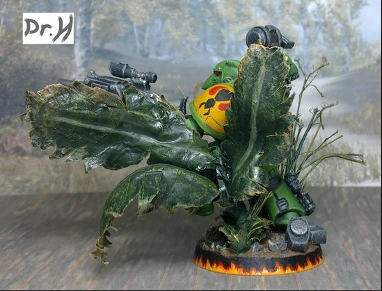 Rear left of the Mantis Warrior space marine mostly obstructed by the leaves he brushes aside.