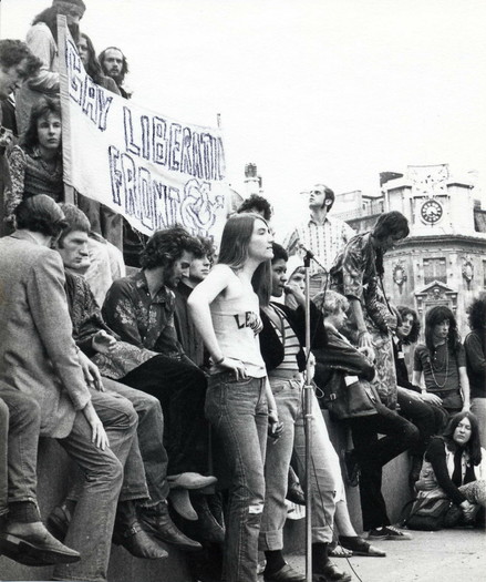 Members of the Gay Liberation Front (GLF) UK, at England's first Gay Pride, 1972 in London, standing in front of a banner that reads: Gay Liberation Front. By LSE Library - Demonstration, with Gay Liberation Front Banner, c1972, No restrictions, https://commons.wikimedia.org/w/index.php?curid=65944937