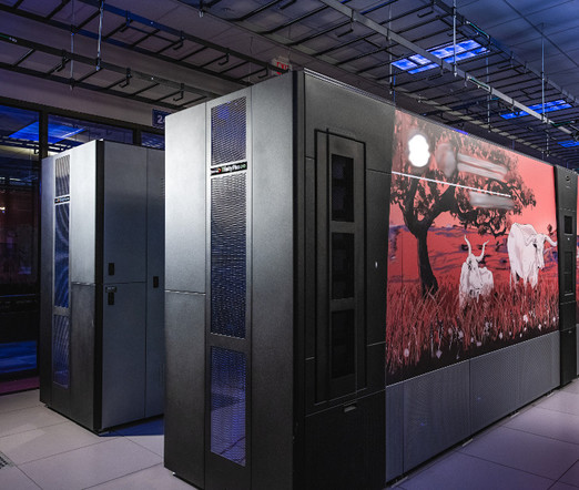 Two data center rack rows with images of cattle against a burnt orange prairie scene.