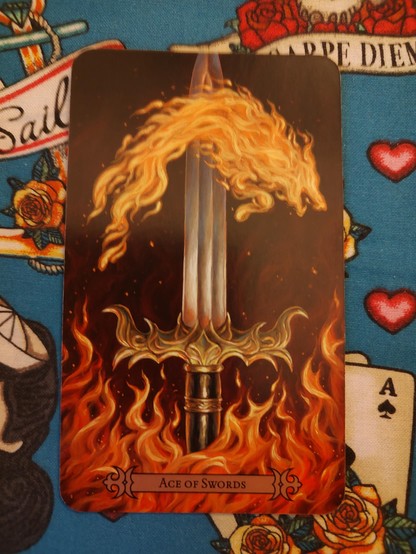 Card from the Modern Spellcaster's Tarot deck. 
Ace of Swords.
A large thick sword pointing upwards, surrounded by fiery flames.