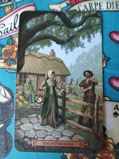 Card from the Modern Spellcaster's Tarot deck.
Ten of Pentacles.
A man and woman, a fence between them, and their house behind them. An older lady behind them as well sitting by the house, and two kids running in the field next to the house.