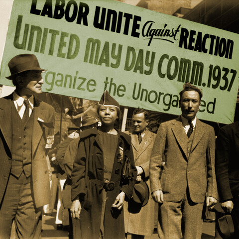 Edith Ransom and Charles Zimmerman (center) of ILGWU Local 22 march with others in the 1937 May Day parade.