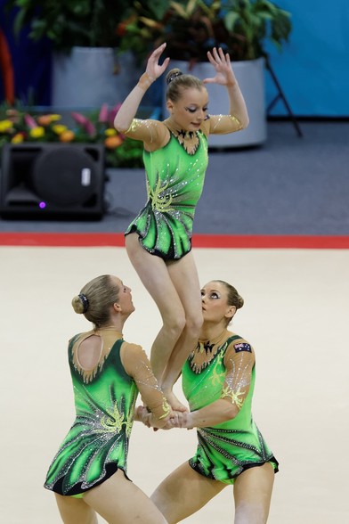 "2014 Acrobatic Gymnastics World Championships, 10th-12 July, Levallois-Perret, France. Finals : women's group. Australia.

Photo by Pierre-Yves Beaudouin (Pyb), 2014, CC BY-SA 4.0.

There are probably better examples of artistic gymnastic and even yoga poses representing the same ideas (trio pike hold? shoulder stand?), but I don't know the terminology well enough to find them.