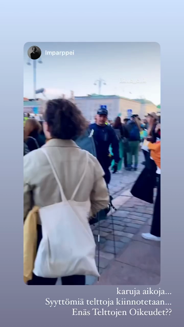 Video by lmparppei shared by Elsi Sloan: a policeman carries away a tent confiscated from a protester on the market square in Helsinki, causing distress for the people caring about the tent's health.