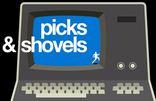 A remix of the cover of the Tor Books edition of 'Picks and Shovels,' depicting a vector art vintage PC, whose blue screen includes a male figure stepping out of the picture to the right. Superimposed on the art is the book's title in a custom, modernist font.
