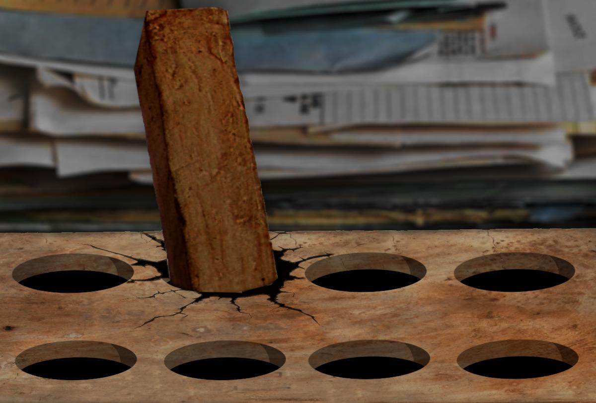 A pegboard into which a square peg has been jammed, cracking the surface. The background is a messy, indistinct pile of papers. A pegboard into which a square peg has been jammed, cracking the surface. The background is a messy, indistinct pile of papers.