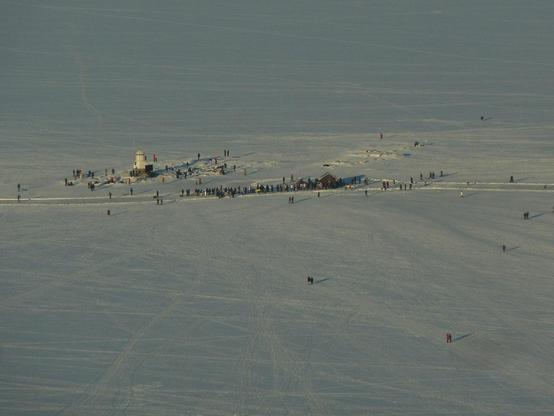 A queue somehow forming in the middle of the frozen lake