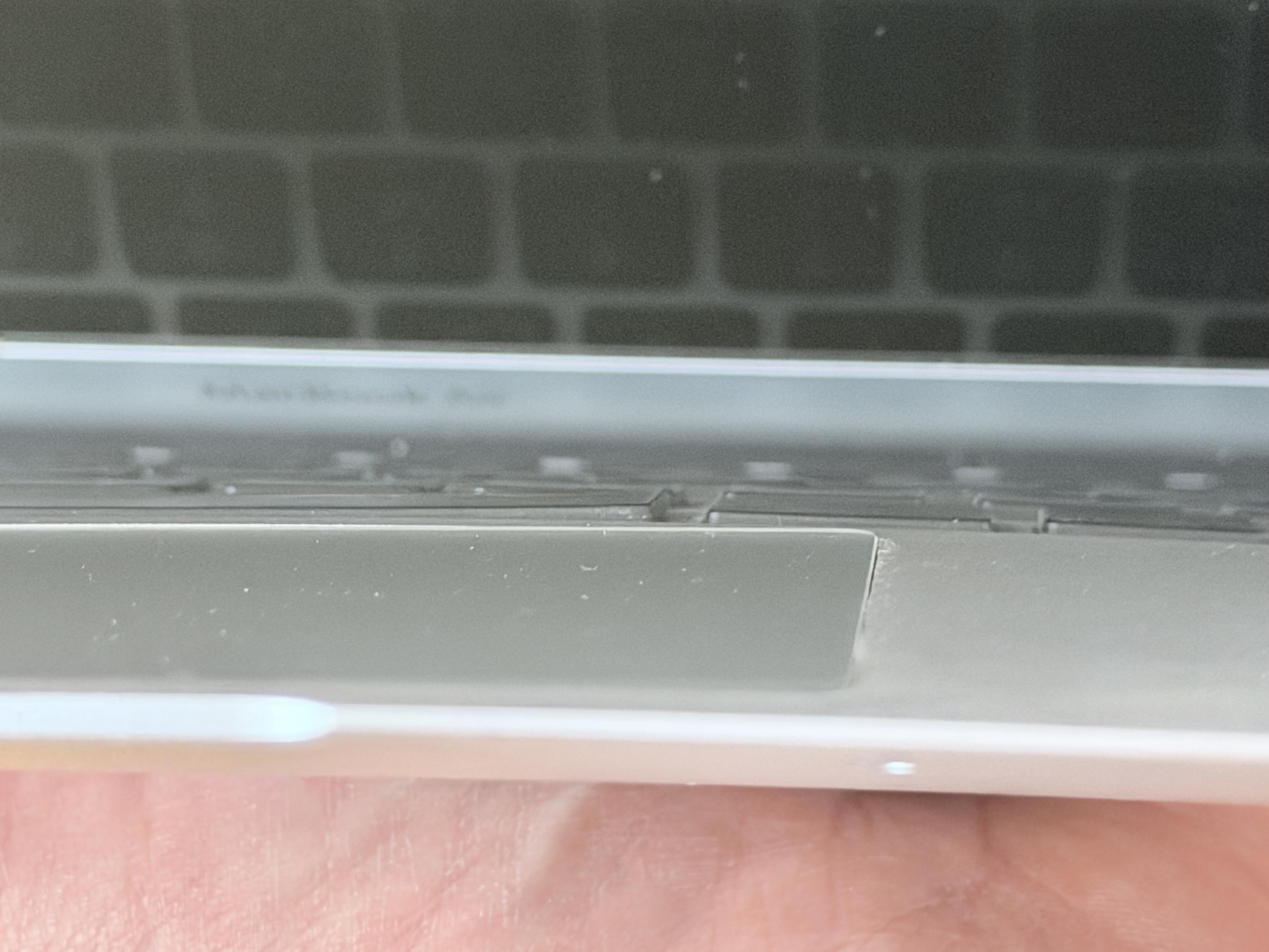 Close-up photo of the swollen lower section (keyboard and trackpad) of my MacBook Air
