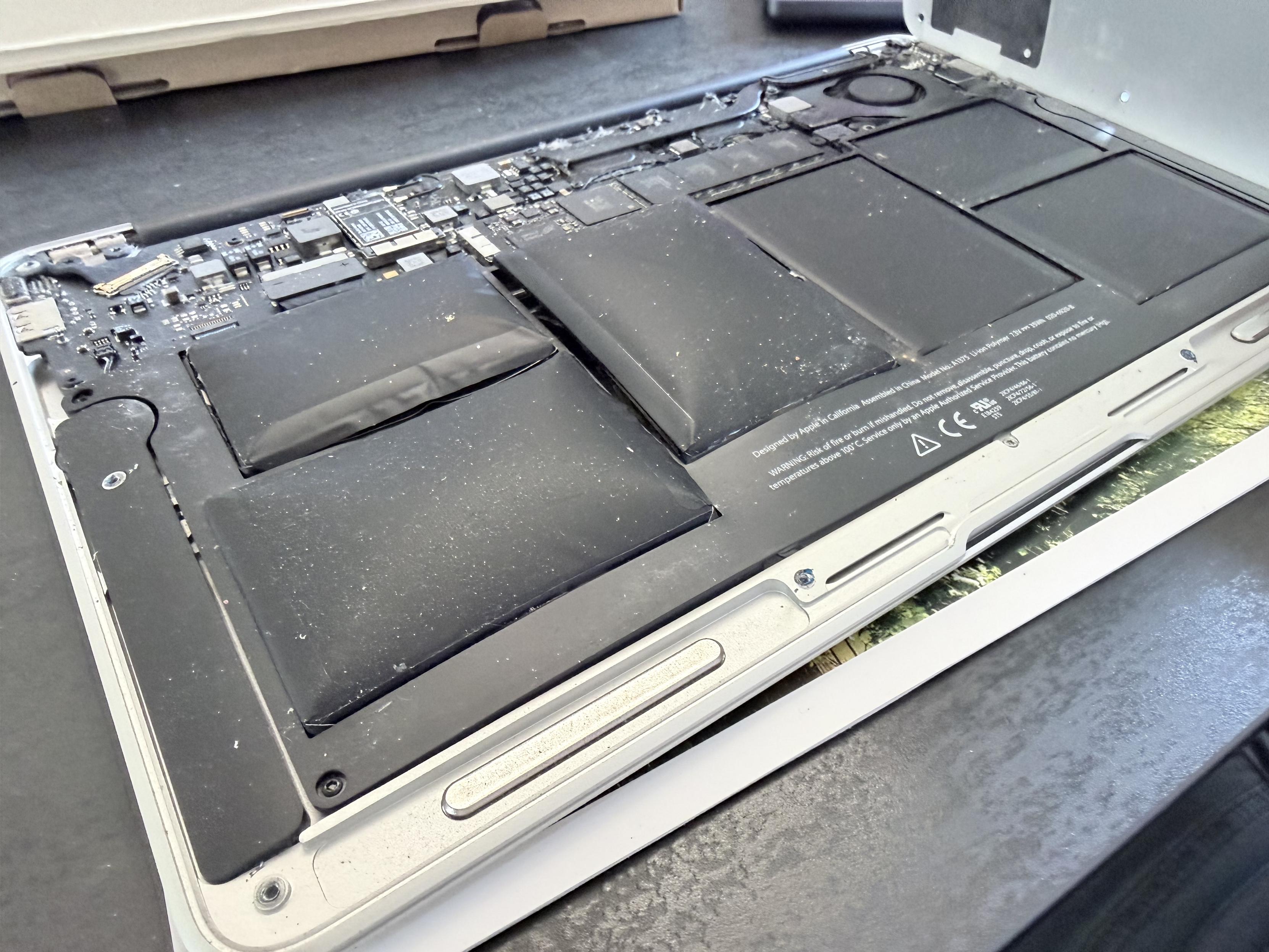 The inside of my 11-inch MacBook Air, with swollen battery cells