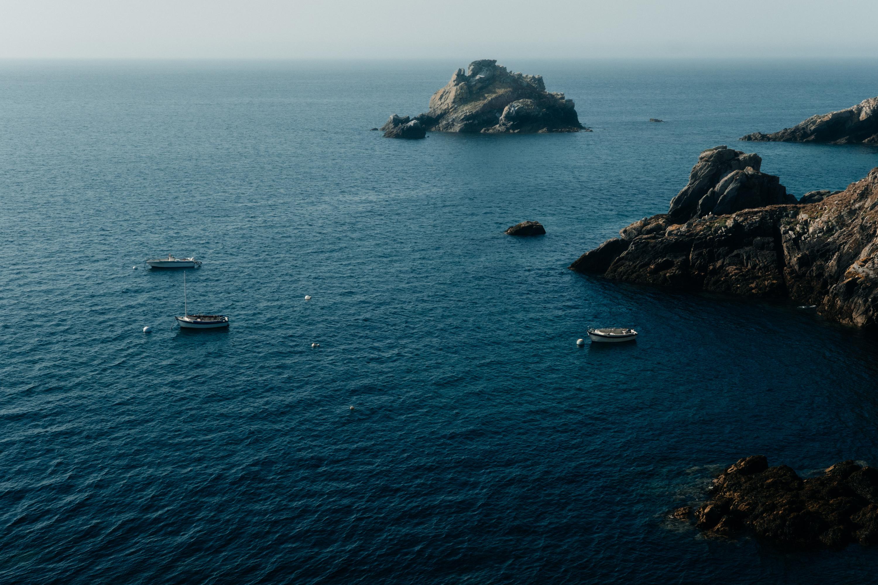 Three boats near shores